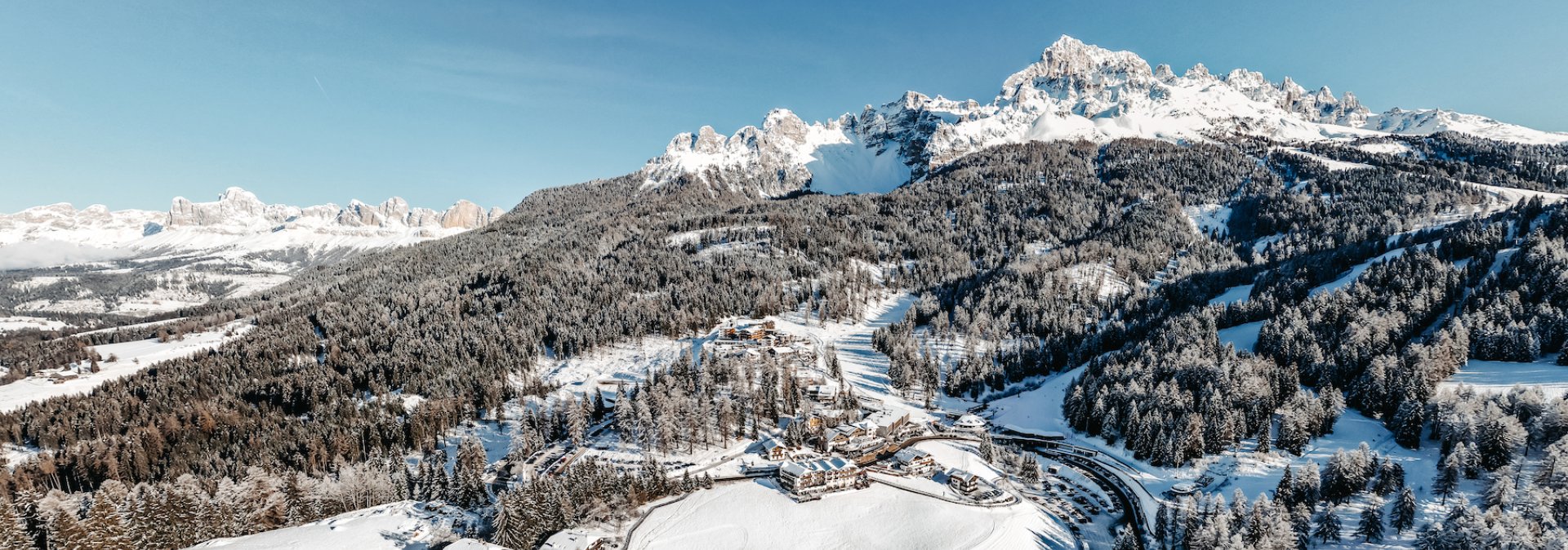 Snowy winter landscape with mountains and forests