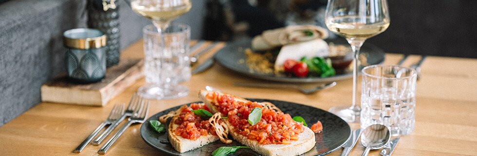 Bruschetta with fresh tomatoes served with white wine