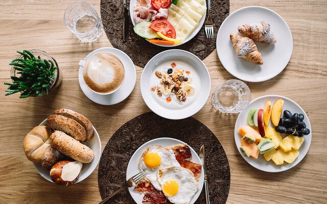 Colazione varia con uova, frutta, yogurt e pane