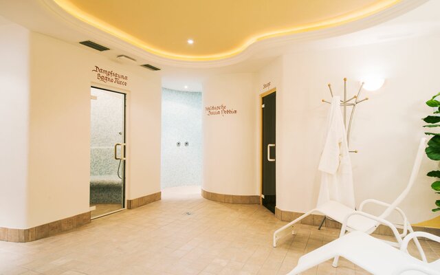 Sauna and steam bath with relaxing loungers.